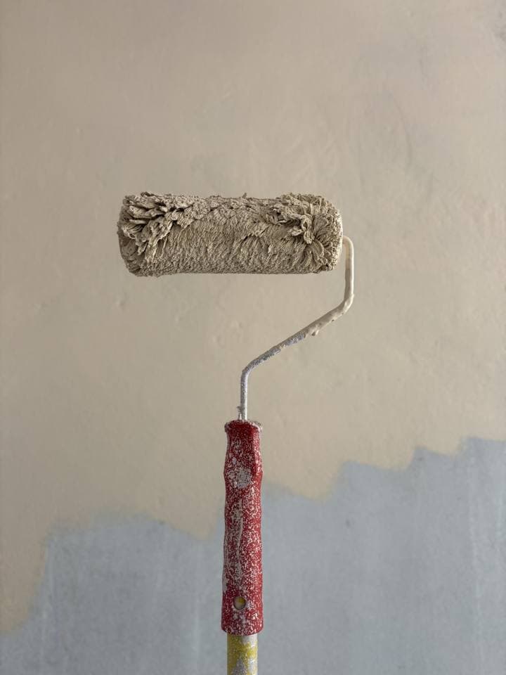 Frisch gestrichene Wand mit Farbrolle